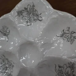 9 Assiettes à huîtres décor fleuri noir KetG Luneville année 1940