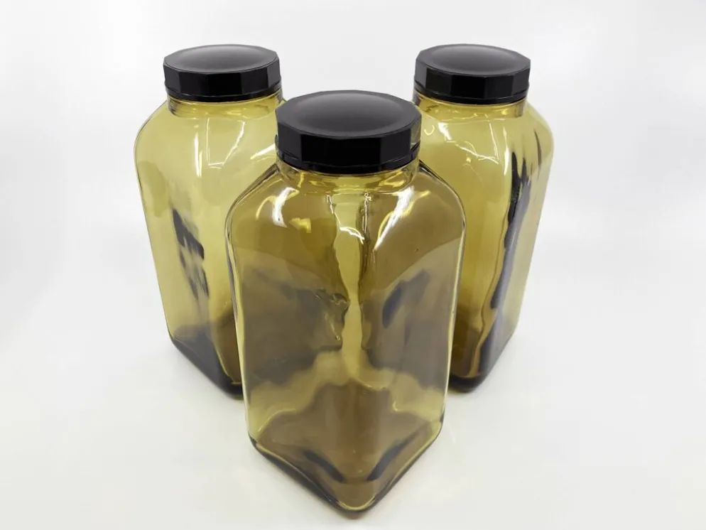 3 bouteilles de pharmacie en verre ambré moulé • bouchons bakélite • 1950