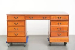 Bureau en bois classique de style anglais avec 4 tiroirs et un dessus en cuir bleu.