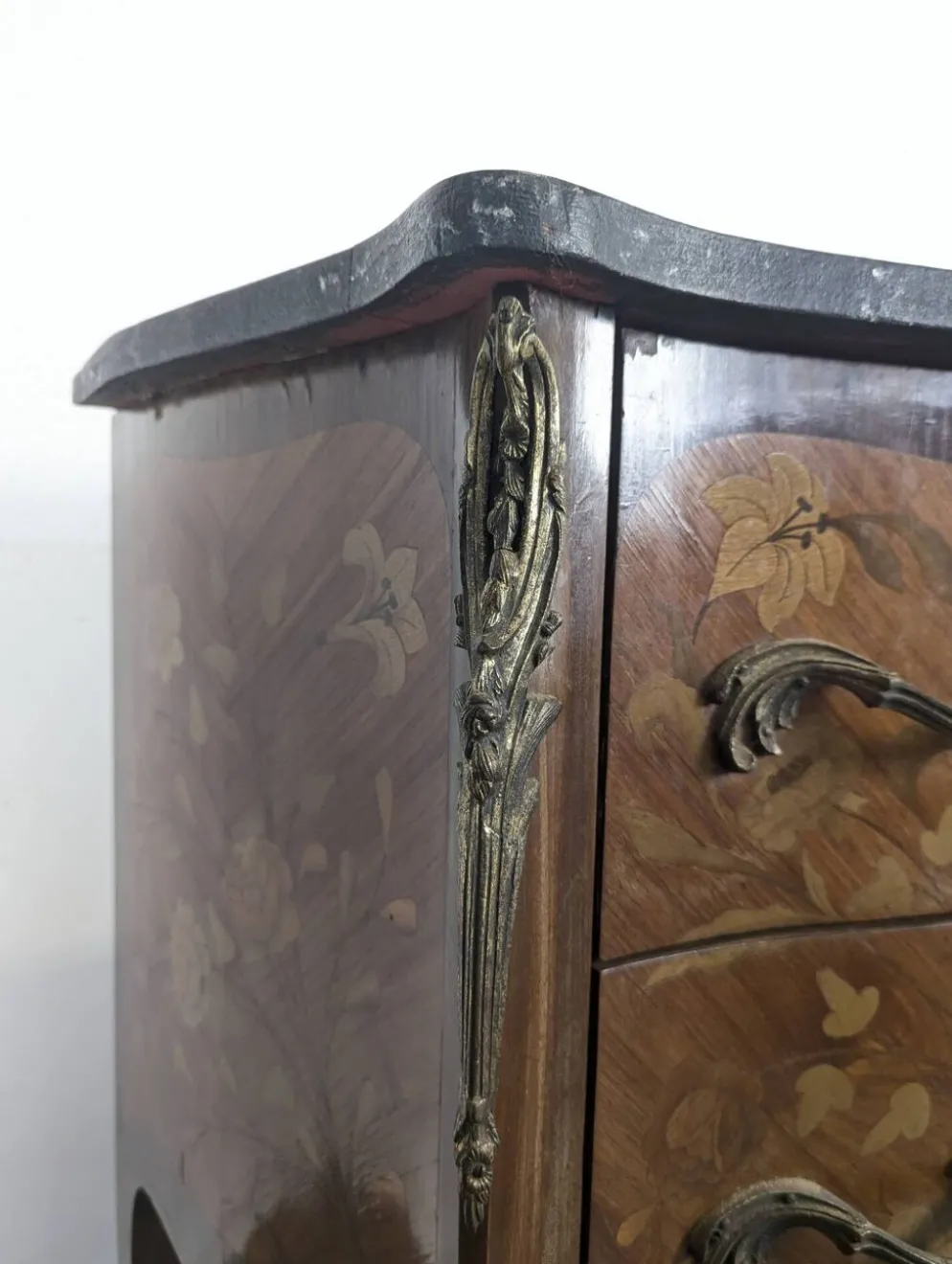 Commode galbée de style Louis XV en marqueterie florale dessus marbre noir