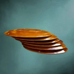 Lot de six assiettes à huîtres Niderviller en faïence émaillée caramel – années 60
