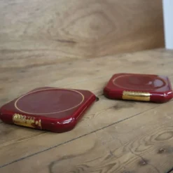 Paire de dessous de plat ou bouteilles en céramique bordeaux avec liseré doré