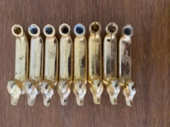 Série de 8 anciens portes couteaux privilège metal doré canard vintage