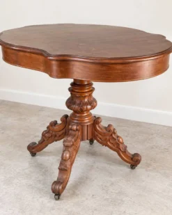 Table ancienne en bois sculpté – plateau chantourné et roulettes